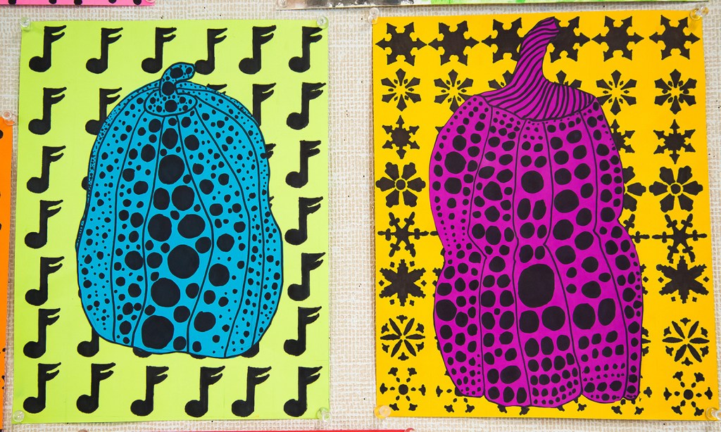 An example of two 5th grade students' Yayoi Kusama style polka-dot pumpkin on a vibrant, patterned background.