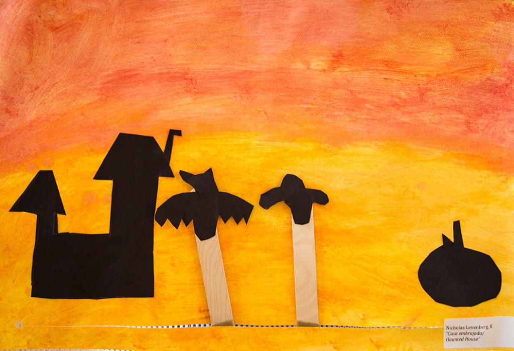 Kindergarten - A student's Halloween shadow puppets of a bat and ghost with sunset background
