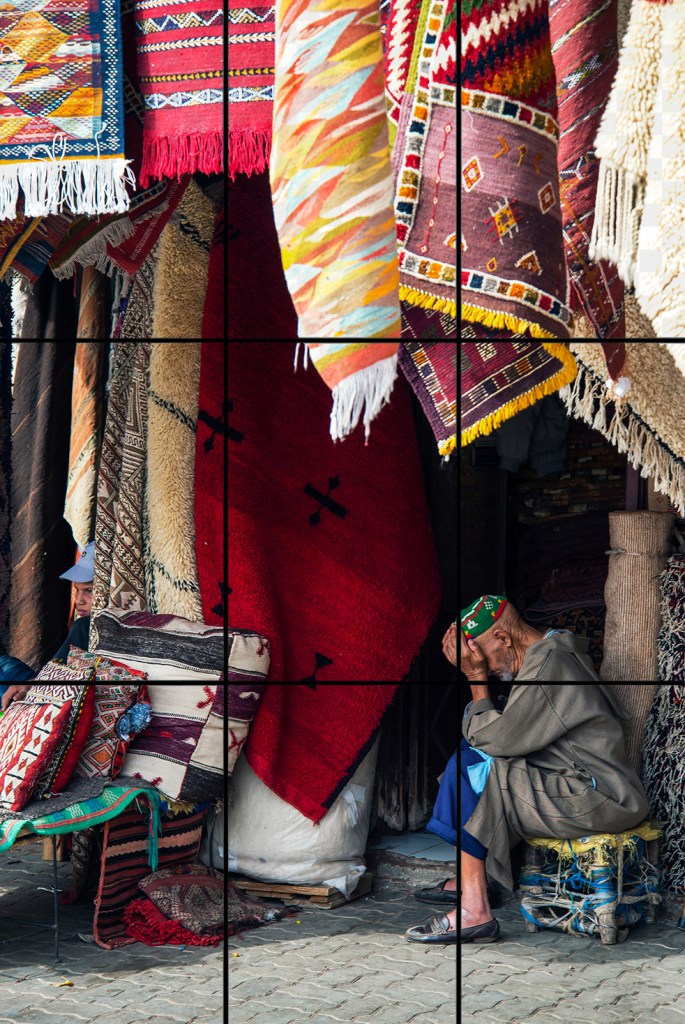 This image demonstrates the rule of thirds; notice the placement of the subject. Rug vendor in Marrakech, Morocco, ©Anita Sagastegui