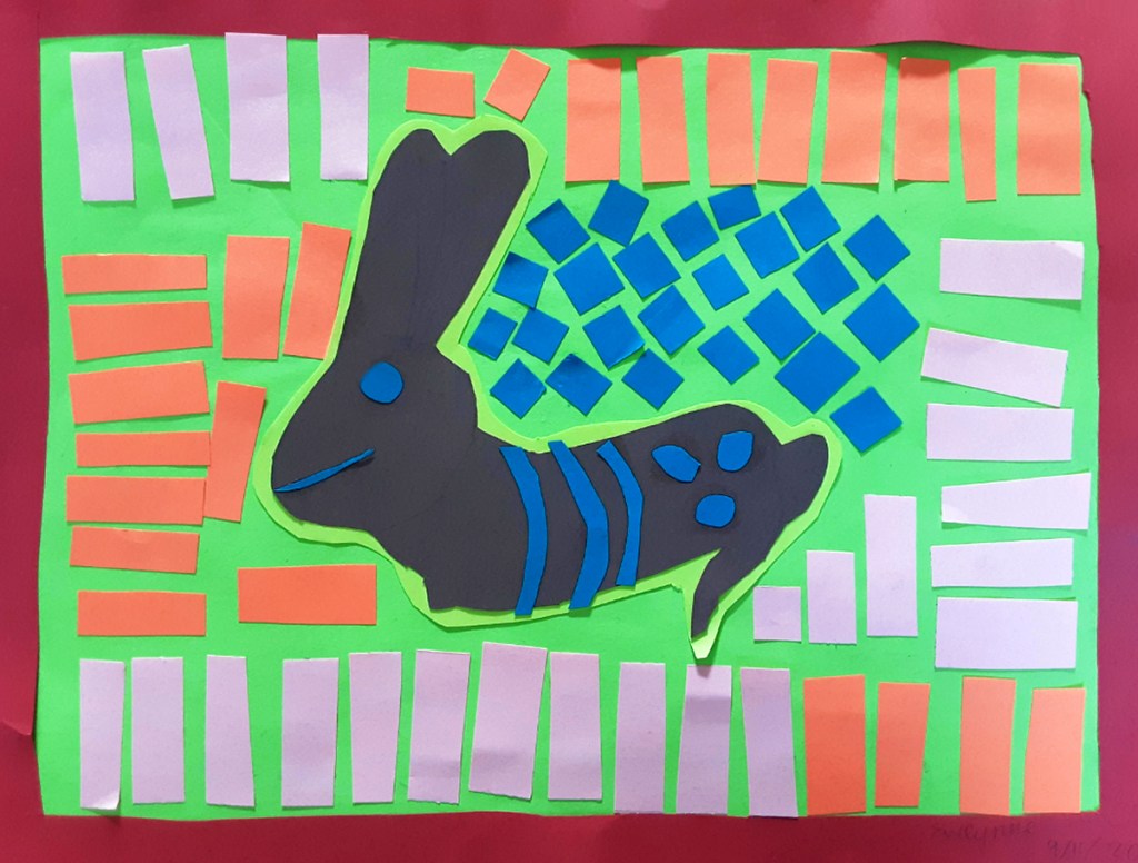 A 4th grade student Mola, depicting a black rabbit surrounded by shapes and lines of various colors