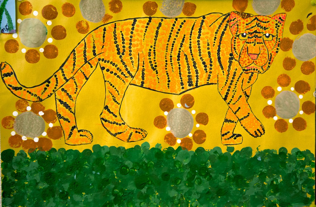 5th grade student's Aboriginal-style Dot Painting of a tiger in bright yellows and oranges.