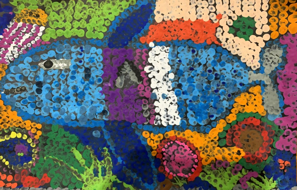 5th grade student's Aboriginal-style Dot Painting of a large fish in vivid rainbow colors.