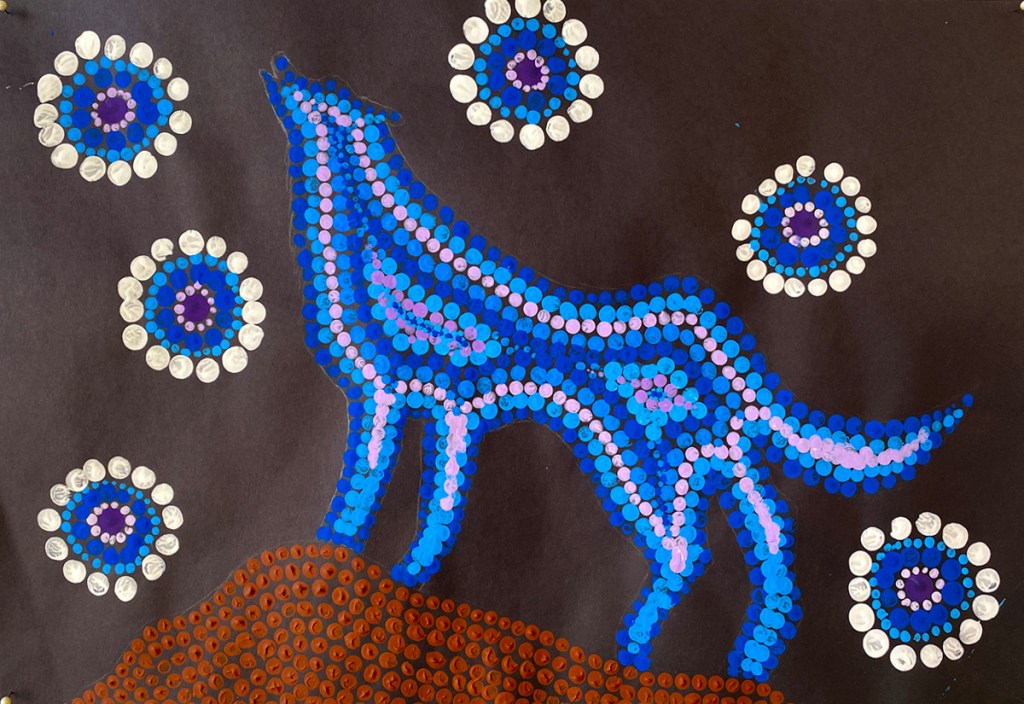 5th grade student's Aboriginal-style Dot Painting of a wolf among bright patterns.