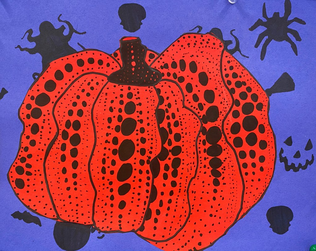 An example of a 5th grade student's Yayoi Kusama style polka-dot pumpkin on a vibrant, patterned background.