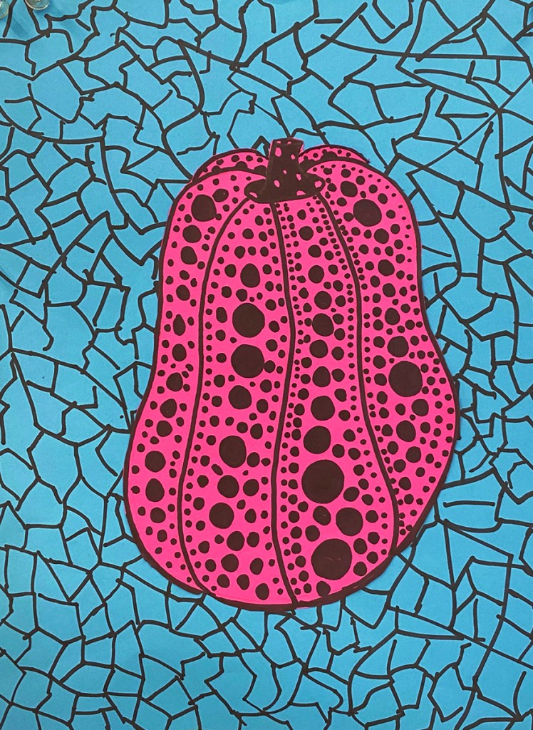 An example of a 5th grade student's Yayoi Kusama style polka-dot pumpkin on a vibrant, patterned background.