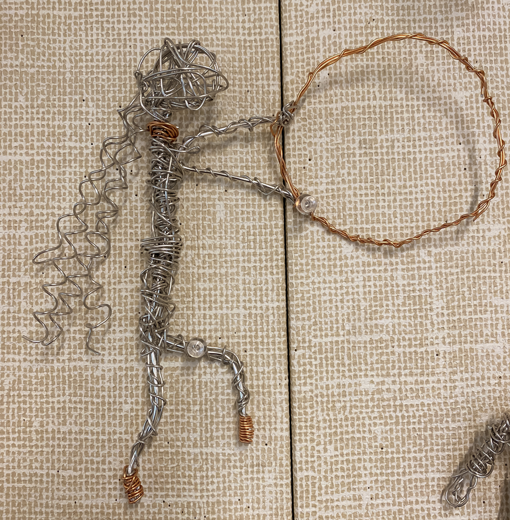 6th grade student's wire figure sculpture of a girl with a hoop