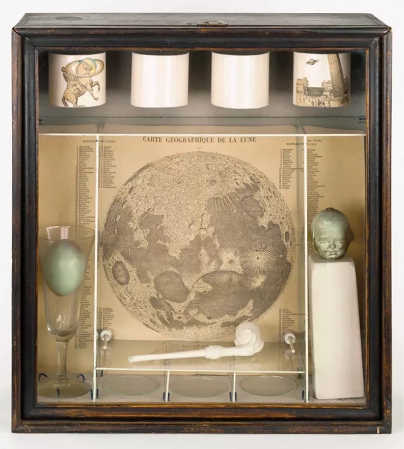One of Joseph Cornell's memory boxes, titled Soap Bubble Set. features a robin's egg, a doll head, a soap bubble set, and a drawing of the moon.