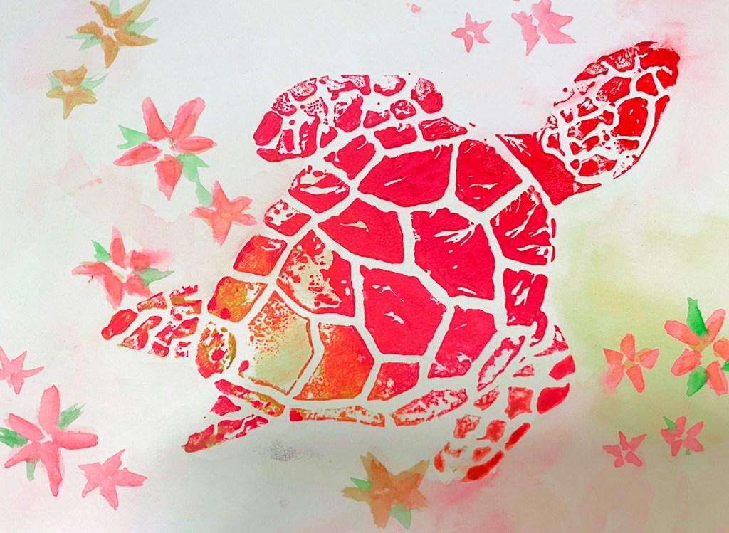 An 8th grade student's linoleum block print. This is a print of an orange and pink turtle surrounded by orange and pink flowers.