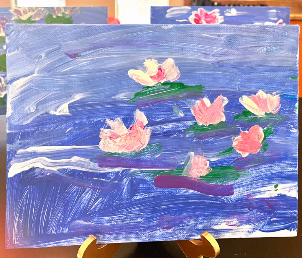 A kindergarten student's painting of water lilies, inspired by Monet's own water lilies paintings. We set these up on little easels for parents to enjoy during our open house.