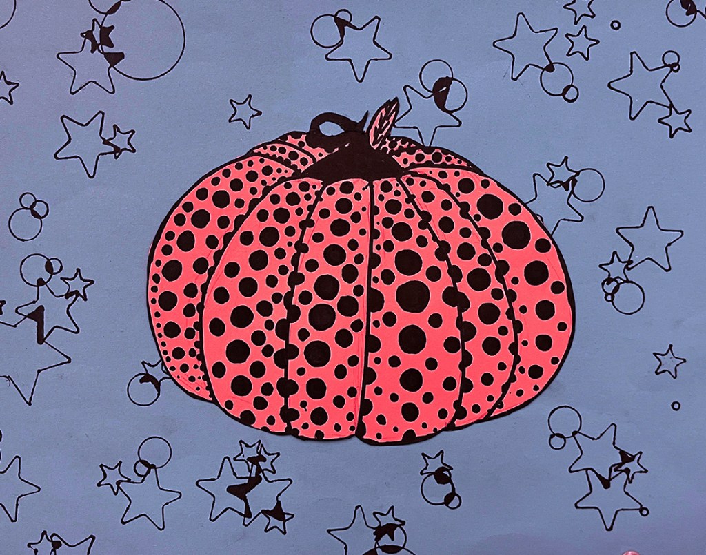 A 5th grade student's Yayoi Kusama-inspired pumpkin. A light red polka-dotted pumpkin on a blue background with a pattern of black stars and circles