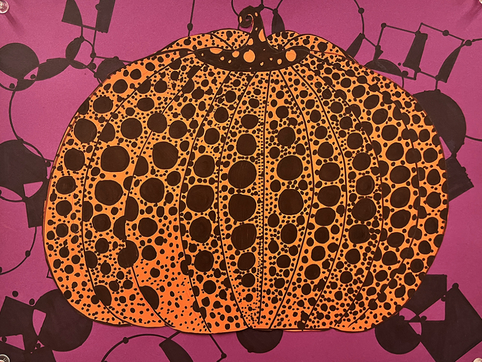 A 5th grade student's Yayoi Kusama-inspired pumpkin. An orange polka-dotted pumpkin on a magenta background with a pattern of black circles, squares and triangles